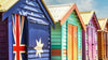 The Brighton bathing boxes on Dendy Street Beach in Melbourne, a row of painted timber huts under a blue sky